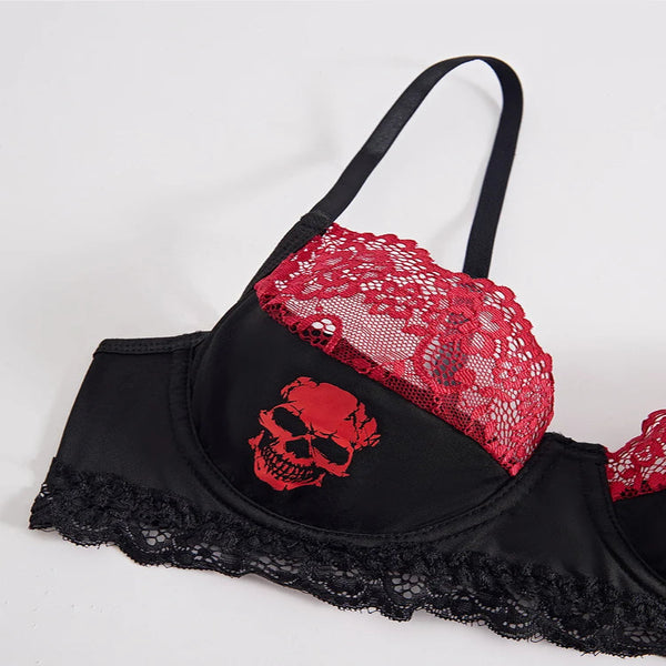 Black bra with red lace and skull design on a white background